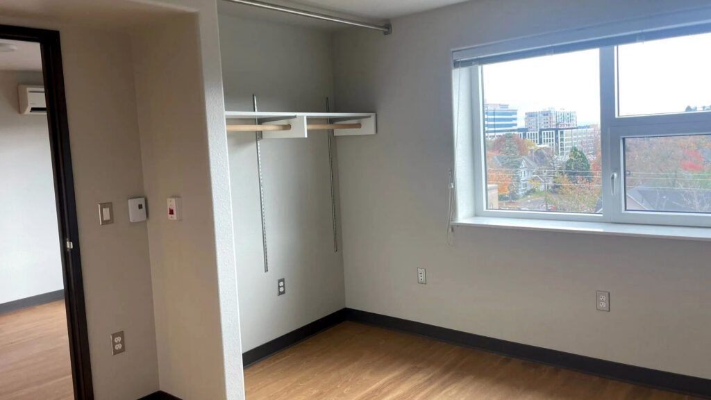 Interior photograph of a room in the building with a window.