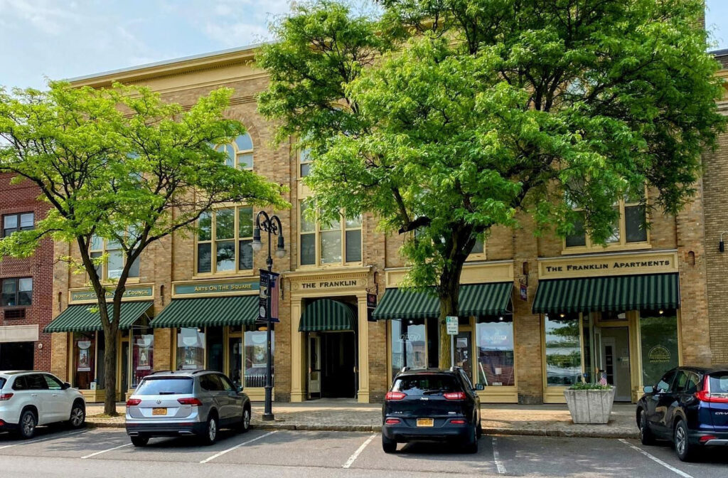 Exterior photograph showing the building's facade through foliage.